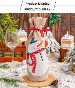 Close-up of burlap Christmas wine bottle bag featuring a detailed snowman embroidery