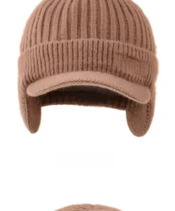 Close-up of brown knit winter hat with ear flaps and Sport embroidery detail