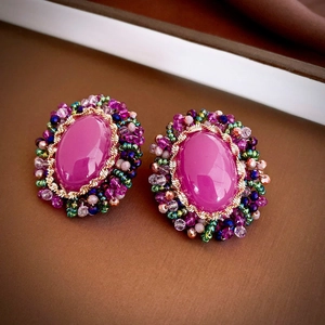 Detailed close-up of retro oval purple crystal flower earrings with colorful bead trim