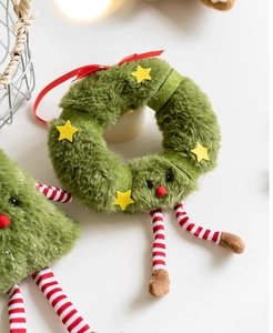 Detail of plush gingerbread man ornament with red ribbon hanger and star decoration