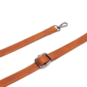 Detail of adjustable brown faux leather shoulder strap with dark gunmetal lobster clasp