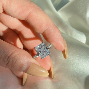 Macro shot of luxury S925 silver ring featuring radiant cut stone and pavé diamond band
