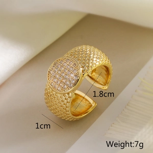 Macro detail of 18K gold plated heart ring with white zircon pave setting on silk