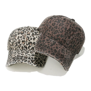 Distressed leopard print baseball caps in light and dark patterns with frayed brims