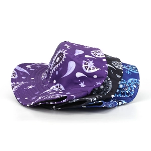 Three bucket hats with paisley print in purple, black and blue shown from a group view