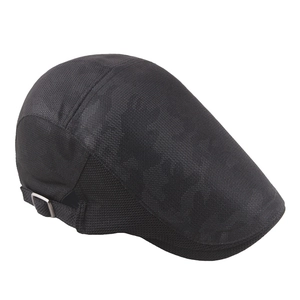 Detail of black mesh newsboy cap side view with adjustable silver metal buckle strap