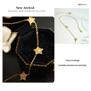 Macro view of gold star pendant necklace with zircons on a black velvet box