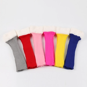 Close-up of knit leg warmers in various colors with white faux fur trim on top