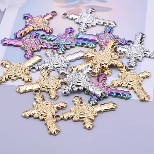 Detailed view of 18k gold and rainbow plated 304 stainless steel rose cross charms