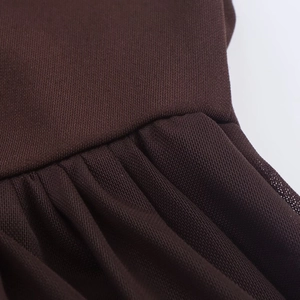 Detail view of ruched dark brown mesh fabric showing fine stitching and pleated texture