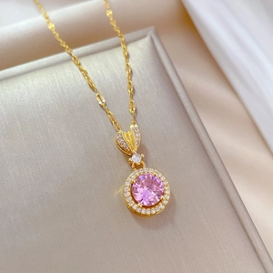 Close-up of titanium necklace with pink crystal pendant and white diamond halo