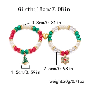 Close-up of magnetic Christmas couple bracelets with tree and snowflake pendants