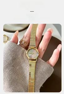 Detailed macro view of GEDI gold watch with iridescent mother-of-pearl dial for women
