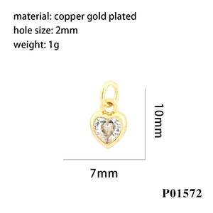 Macro detail of heart-shaped gold plated copper pendant with zircon inlay and measurements