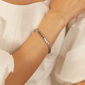 Minimalist silver stainless steel hollow heart chain bracelet worn on female wrist
