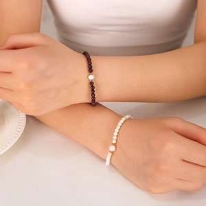 Stack of 18K gold plated stainless steel bracelets with natural pearls and red garnet beads