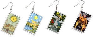 Close-up of four acrylic tarot earrings featuring The Moon, Star, Tower, and Devil cards