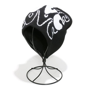 Detailed close-up of a knit beanie with black and white LOVE jacquard pattern on a stand