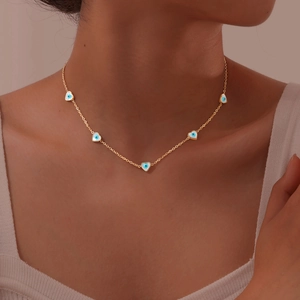 Golden choker necklace featuring multiple heart charms with blue evil eye enamel motifs