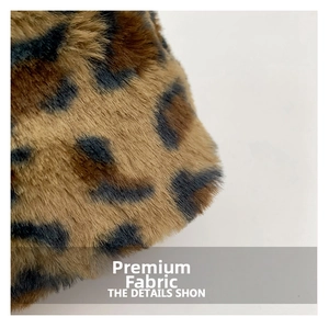 Detailed close-up of leopard print faux fur fabric with plush brown and black textures