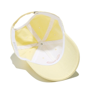 Detailed interior of a 100% cotton baseball cap showing reinforced seams and metal buckle