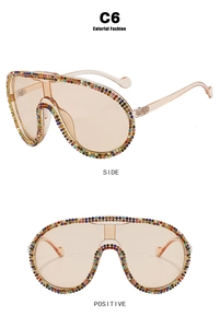 Detail of oversized shield sunglasses with colorful rhinestones and light brown lenses