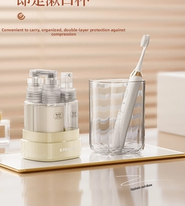 Detail of portable 35ml travel spray and lotion bottles set in a cream storage base