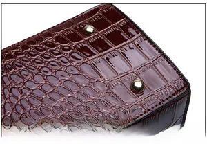 Detail of reddish-brown crocodile embossed leather bottom with protective metal feet