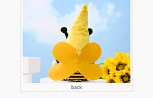 Detail view of the yellow felt wings and striped back of a plush bee gnome doll