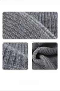 Macro view of thick dark grey wool knit fabric texture and warm fiber details of the hat