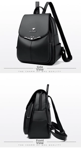 Macro detail of black lychee leather backpack with metal kangaroo logo and heart lock