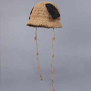 Close-up of hand-woven crochet bucket hat with cute black dog ears and adjustable ties