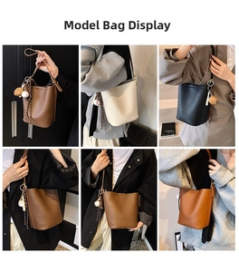 Litchi pattern bucket bag with baseball charm shown in brown, white, and black colors