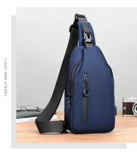 Macro view of navy blue sling bag with waterproof vertical zipper on wooden surface