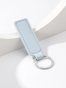 Close-up of light blue PU leather rectangle keychain with silver ring on white background