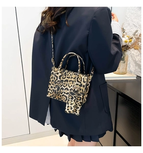 Detail view of leopard print crossbody bag with adjustable strap and matching coin purse