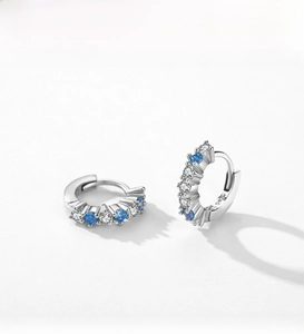 Close-up of S925 sterling silver hoop earrings set with blue and white zircons