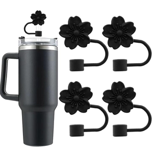 Detail of 10mm black silicone flower straw covers paired with a large stainless steel mug