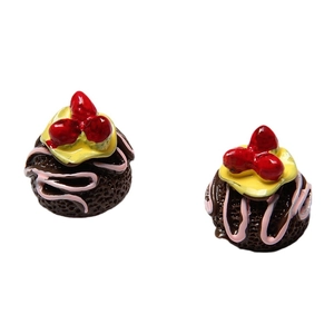 Miniature resin chocolate cake toy with strawberry topping on white background