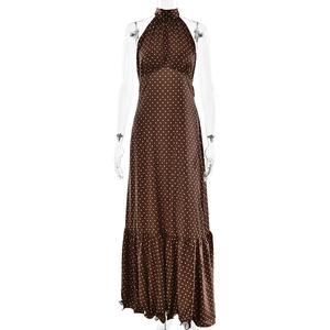 Detailed close-up of brown polka dot halter maxi dress with elegant ruffle hem finish