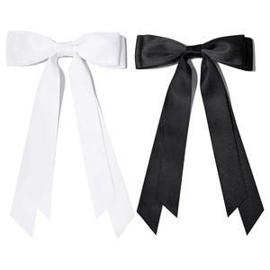 Detail of black and white satin hair bow clips with elegant long double ribbon tassels