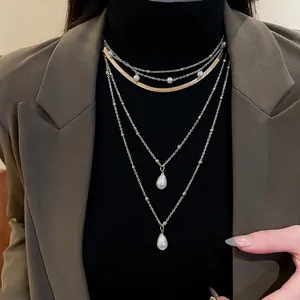 Multi-layer gold-plated necklace with teardrop pearl pendants and tiered chain design