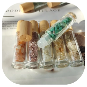 Close-up of glass essential oil bottles with natural crystal stones and bamboo caps