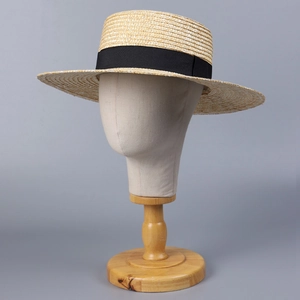 Classic straw boater hat with a wide black ribbon bow for summer beach sun protection