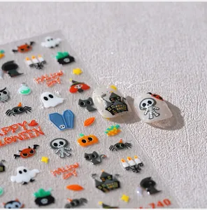Macro shot of Halloween 3D nail stickers featuring pumpkins, ghosts, and bats decorations