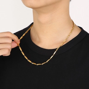 Close-up of a gold geometric link chain necklace worn on neck for a stylish hip-hop look