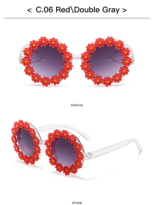 Detail view of red sunflower daisy sunglasses for kids with purple gradient lenses