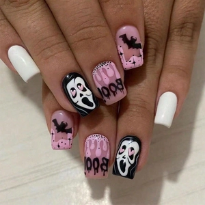 Halloween press-on nails featuring pink and black ghost face, bats, and drip art designs