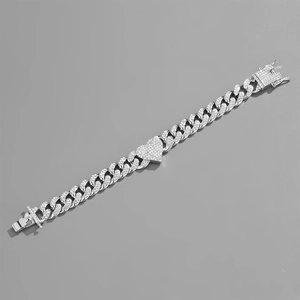 Silver Cuban link bracelet with iced-out heart pendant and shimmering rhinestones