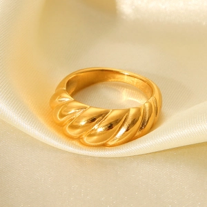 Polished gold croissant dome ring on elegant beige satin background for women